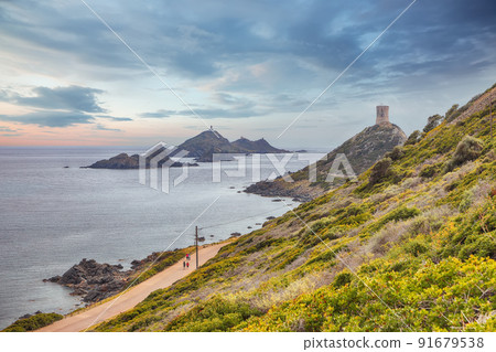 Sunset over popular tourist destination Torra di a Parata with Genoese Tower 91679538