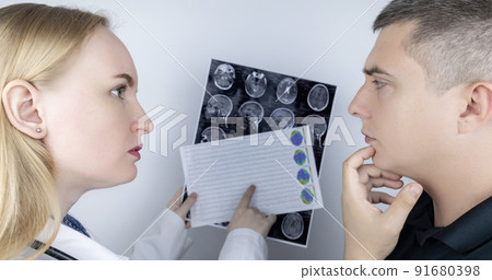 Epileptologist examines patient MRI and electroencephalogram. Concept treating epilepsy and helping people who suffer from this disease. Neurologist at work. Pathology of the brain. Seizure activity Epileptologist examines patient MRI and electroencephalogram. Concept treating epilepsy and helping people who suffer from this disease. Neurologist at work. Pathology of the brain. Seizure activity 91680398
