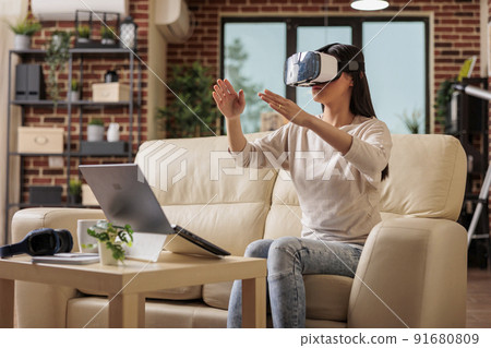 Happy asian woman enjoying wearing VR virtual reality headset, modern glasses technology headset future device gadget digital entertainment game simulation Happy asian woman enjoying wearing VR virtual reality headset, modern glasses technology headset future device gadget digital entertainment game simulation 91680809