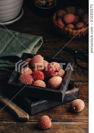 Litchi Fruits in Wooden Container 91680870