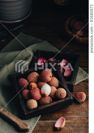 Litchi Fruits in Wooden Container 91680873