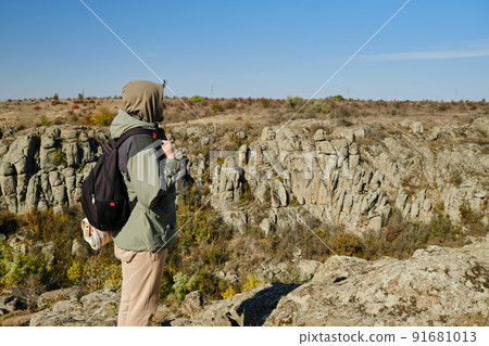 Hiker young man with backpack at the mountains Hiker young man with backpack at the mountains 91681013