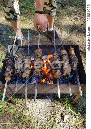 Raw kebab grilling on metal skewer. Raw kebab grilling on metal skewer. 91681066
