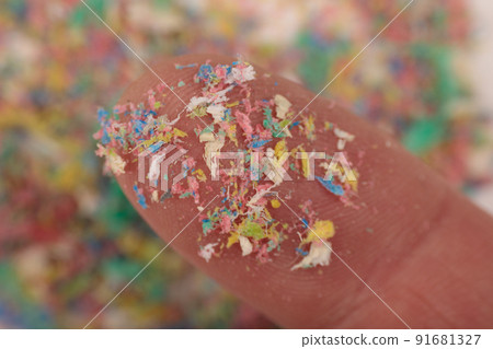 Finger close-up with traces of plastic and microplastic, environmental pollutant. 91681327