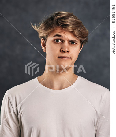 young handsome man with a doubt on his face in t-shirt young handsome man with a doubt on his face in t-shirt 91681461