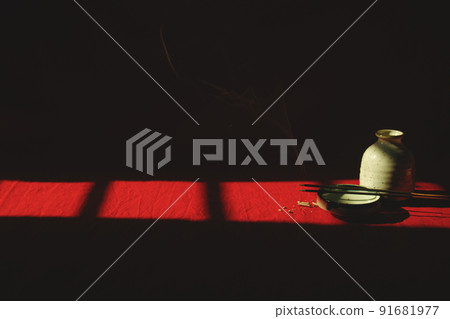 Light and shadows cast on a porcelain container and incense sticks showing the concept of meditation, mindfulness and mental wellbeing Light and shadows cast on a porcelain container and incense sticks showing the concept of meditation, mindfulness and mental wellbeing 91681977