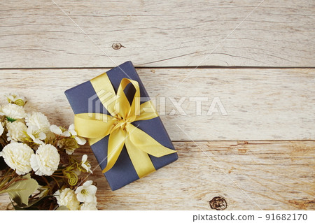 Gift box with pink ribbon with space copy on wooden background Gift box with pink ribbon with space copy on wooden background 91682170