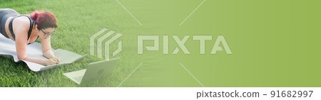 Banner young plus size woman in sporty top and leggings standing in plank on yoga mat spending time on green grass in yard. Black kitten walks around her. Well being and fitness concept copy space 91682997