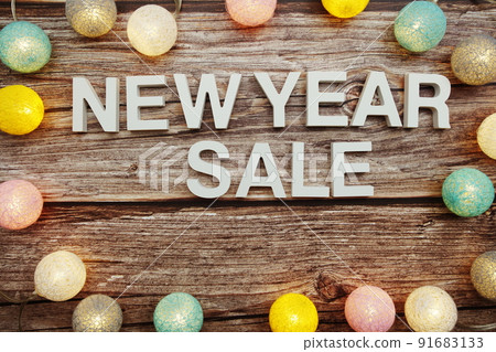 New Year Sale alphabet letters decorate with LED cotton balls on blue background New Year Sale alphabet letters decorate with LED cotton balls on blue background 91683133