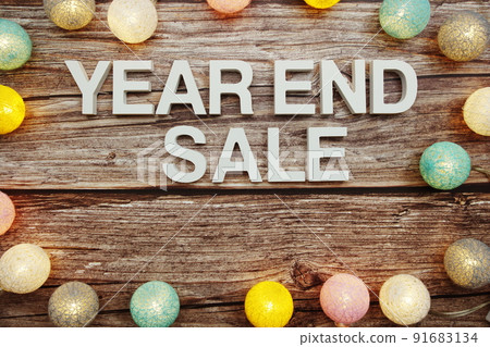 Year End Sale alphabet letters decorate with LED cotton balls on wooden background 91683134