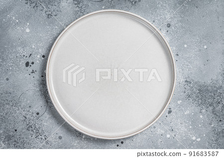 Empty white plate on table. Food cooking and healthy eating background. Gray background. Top view. Copy space Empty white plate on table. Food cooking and healthy eating background. Gray background. Top view. Copy space 91683587