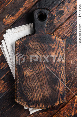 Empty wooden Cutting board over towel on kitchen table, healthy cooking background. Wooden background. Top view. Copy space Empty wooden Cutting board over towel on kitchen table, healthy cooking background. Wooden background. Top view. Copy space 91683590