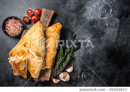 Uzbek and Central Asia samsa, samosa pies. Black background. Top view. Copy space Uzbek and Central Asia samsa, samosa pies. Black background. Top view. Copy space 91683611