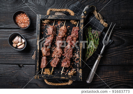 BBQ Beef veal shish kebab Skewers. Black background. Top view 91683773