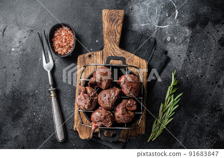 Grilled Beef veal kidney, offal meat on grill. Black background. Top view 91683847