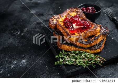 Raspberry French Toast with butter on marble board. Black background. Top view. Copy space 91683854