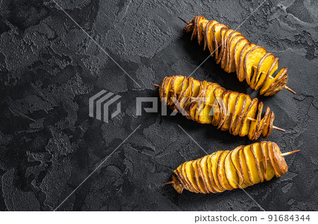 Twisted tornado potatoes chips. Black background. Top view. Copy space Twisted tornado potatoes chips. Black background. Top view. Copy space 91684344