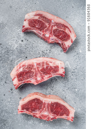 Raw fresh meat lamb mutton saddle. Gray background. Top view 91684368