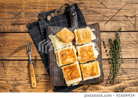 Delicious Turkish Tray pastry, Su boregi with cheese. Wooden background. Top view Delicious Turkish Tray pastry, Su boregi with cheese. Wooden background. Top view 91684434