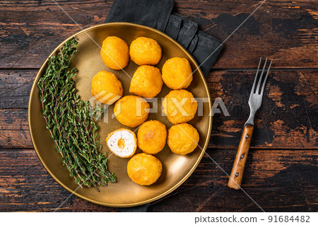 Fried crispy round chicken nuggets with Cheese. Wooden background. Top view 91684482