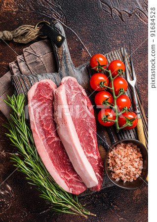 Raw Picanha meat steak, traditional Brazilian beef cut with thyme. Wooden background. Top view 91684528