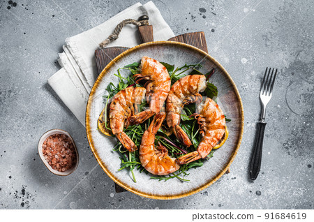 Salad with grilled Giant shrimps prawns in plate. Gray background. Top view Salad with grilled Giant shrimps prawns in plate. Gray background. Top view 91684619