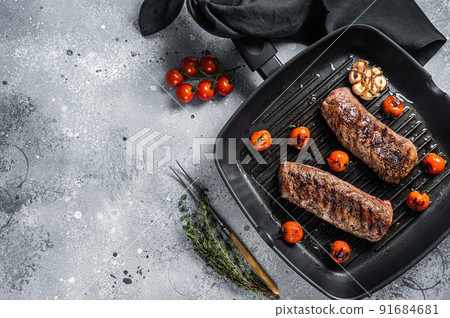 Roasted Lamb tenderloin fillet meat on grill pan, mutton sirloin steak. Gray background. Top view. Copy space Roasted Lamb tenderloin fillet meat on grill pan, mutton sirloin steak. Gray background. Top view. Copy space 91684681