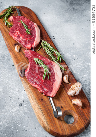 Raw Picanha Brazilian Grilling Steaks with herbs and spices. Gray background. Top view 91684752