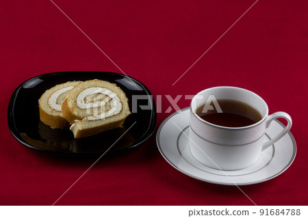 Slices of Cake with Cup of Tea on a Red Table Cover Slices of Cake with Cup of Tea on a Red Table Cover 91684788