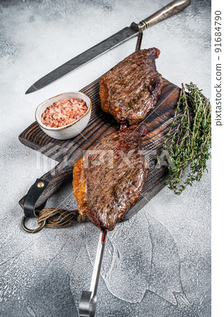 Barbecue grilled dry aged wagyu Brazilian picanha from the sirloin cap beef meat. White background. Top view 91684790