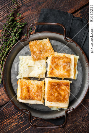 Turkish Su Boregi, Tabla borek or Adana Borek with cheese. Wooden background. Top view 91685235