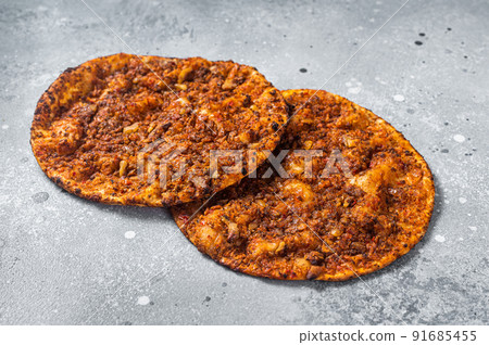 Turkish pizza lahmacun on kitchen table. Gray background. Top view Turkish pizza lahmacun on kitchen table. Gray background. Top view 91685455
