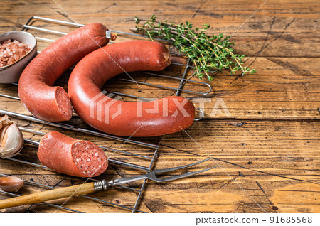 Turkish Sucuk beef meat sausage on a grill. Wooden background. Top view. Copy space Turkish Sucuk beef meat sausage on a grill. Wooden background. Top view. Copy space 91685568