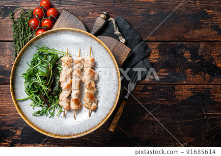 Chicken skewers souvlaki, grilled meat shish kebab skewers. Wooden background. Top view. Copy space 91685614