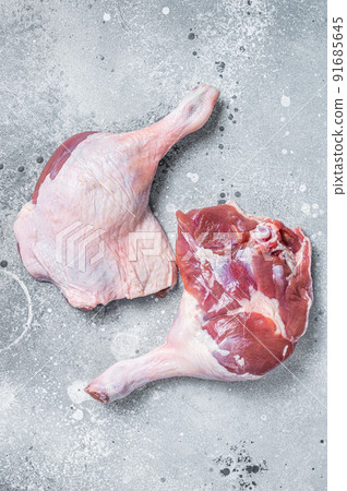 Fresh raw duck legs on a kitchen table. Gray background. Top view 91685645