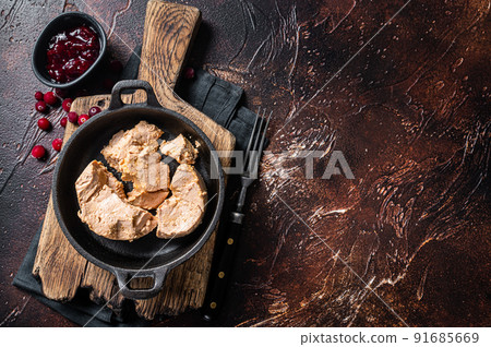 Franch Foie gras duck liver pate with lingonberry marmalade. Dark background. Top view. Copy space Franch Foie gras duck liver pate with lingonberry marmalade. Dark background. Top view. Copy space 91685669