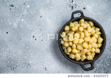 Cooked Gnocchi with Butter and Pepper. Gray background. Top view. Copy space 91685973