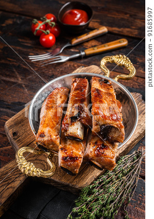 Barbecue chopped pork spare ribs in a skillet. Wooden background. Top view Barbecue chopped pork spare ribs in a skillet. Wooden background. Top view 91685997