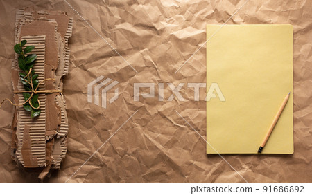 Waste cardboard and notebook at crumpled paper background texture. Recycling concept 91686892