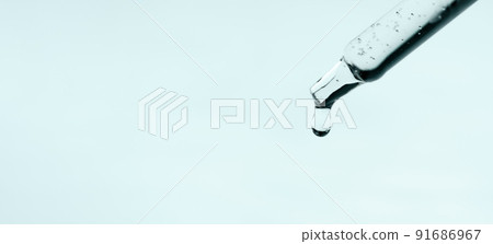Closeup of pipette with serum, hyaluronic acid on blue background. Cosmetics and healthcare concept. Dose of essential oill, retinol with air bubbles. Beauty product presentation, front view, macro Closeup of pipette with serum, hyaluronic acid on blue background. Cosmetics and healthcare concept. Dose of essential oill, retinol with air bubbles. Beauty product presentation, front view, macro 91686967