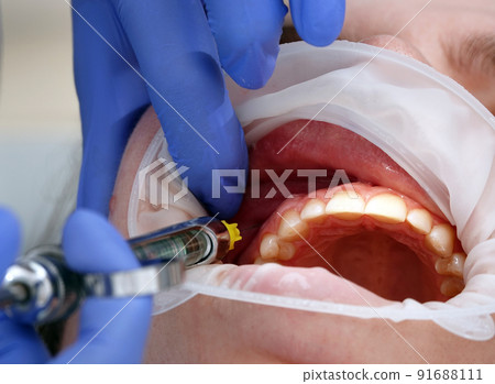Doctor dentist makes anesthesia to the patient Doctor dentist makes anesthesia to the patient 91688111