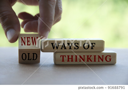 Hand turning wooden cube text from OLD to New ways of thinking. New normal concept 91688791