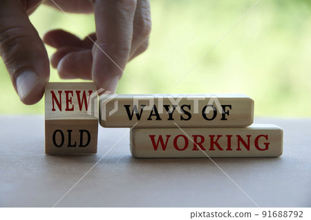 Hand turning wooden cube text from OLD to New ways of working. New normal concept Hand turning wooden cube text from OLD to New ways of working. New normal concept 91688792