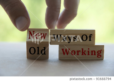 Hand turning wooden cube text from OLD to New ways of working on wooden blocks. New normal concept Hand turning wooden cube text from OLD to New ways of working on wooden blocks. New normal concept 91688794