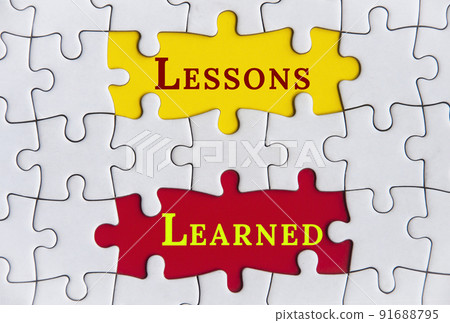 Lessons learned text on Jigsaw Puzzle with yellow and red background. Improvement concept Lessons learned text on Jigsaw Puzzle with yellow and red background. Improvement concept 91688795