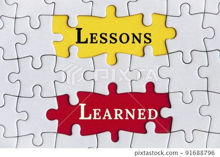 Top view of lessons learned text on Jigsaw Puzzle. Improvement concept Top view of lessons learned text on Jigsaw Puzzle. Improvement concept 91688796