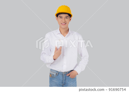 Portrait young asian man is engineer wearing helmet standing and holding blueprint with confident. 91690754