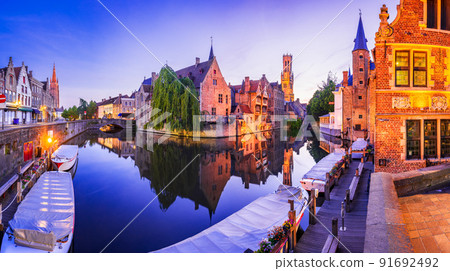 Bruges, Belgium. Rozenhoedkaai illuminated at night, old town with Belfry reflection 91692492