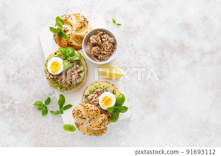 Canned tuna open sandwiches. Buns burgers with canned tuna, boiled egg and avocado 91693112
