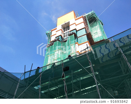 SELANGOR, MALAYSIA -JULY 16, 2018: Safety netting is installed at the high rise building exterior scaffolding during construction. Its avoid building object falling directly to the ground. 91693842